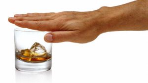 Man Covering Whiskey Glass With Hand